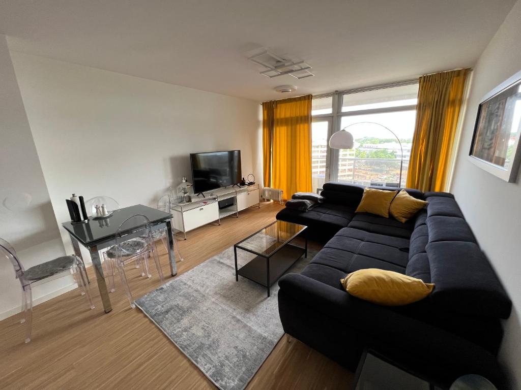 a living room with a couch and a table at Apartment Domblick in Cologne
