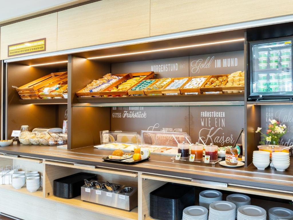 a bakery with a lot of food on display at B&B Hotel Mönchengladbach in Mönchengladbach