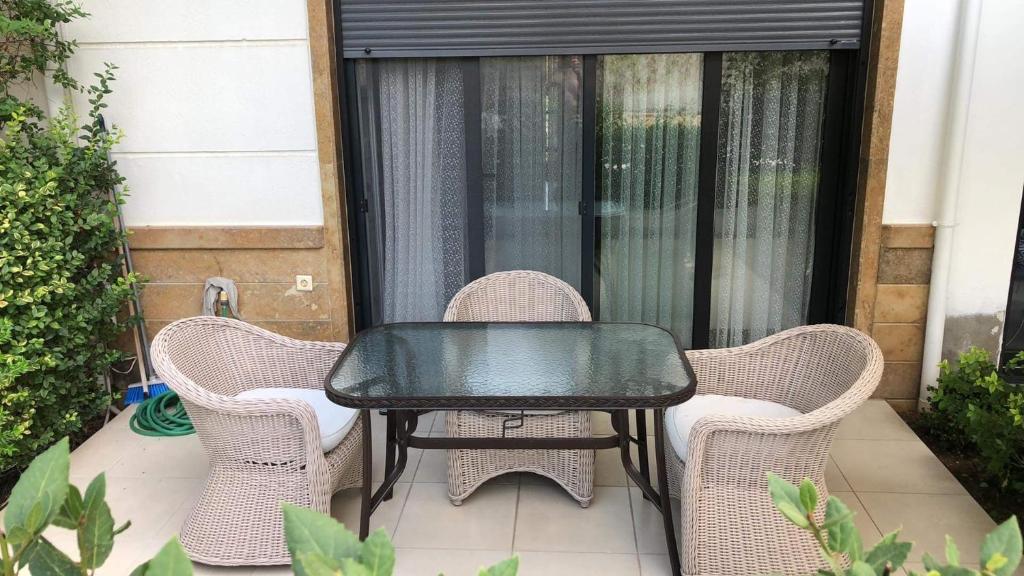a table and four chairs on a patio at Mema´s Maisonette! in Nea Fokea