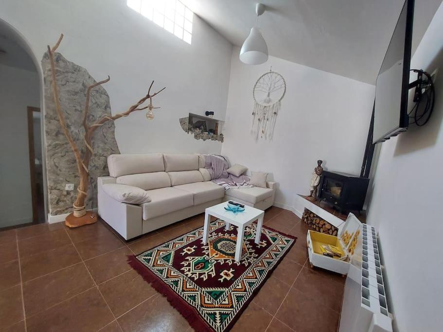 a living room with a couch and a table at La Quibla de Abuhan in Caudé