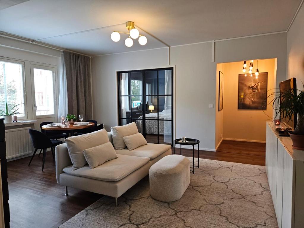 a living room with a couch and a table at Little Paris, 1 bedroom apartment in Pietarsaari