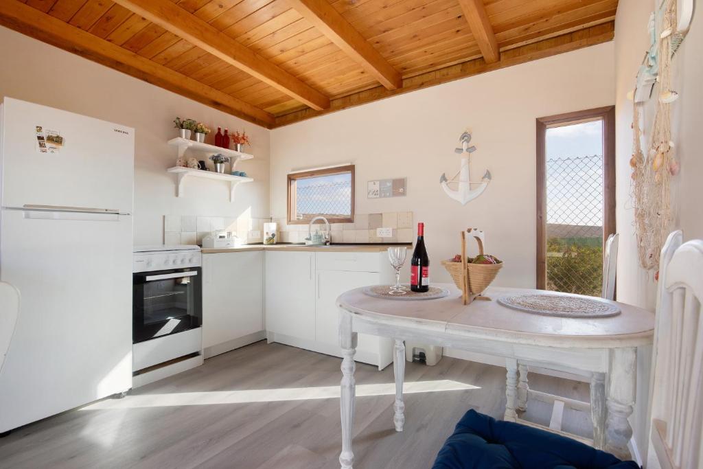 a kitchen with a table with wine bottles on it at Casa Barranco de la Sal in Puerto del Rosario