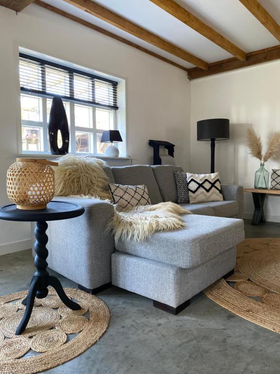 a living room with a couch and a table at Vakantie-Appartement WedderheideHoeve in Wedde