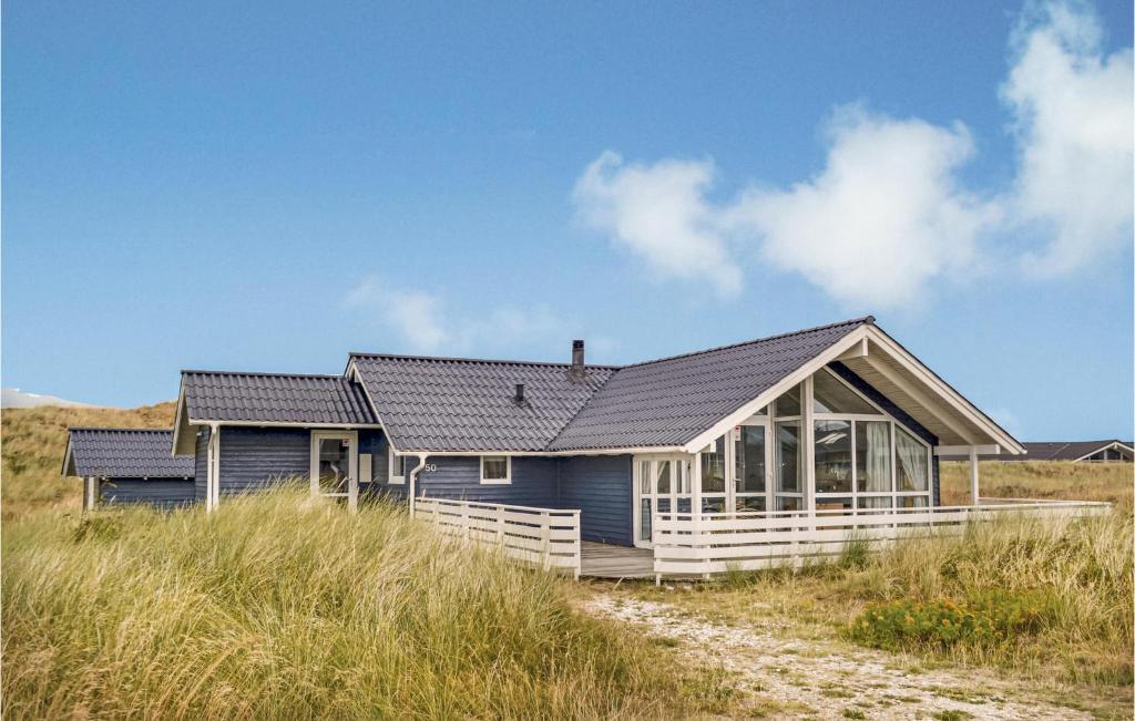 a house on a beach in the sand at Nice Home In Hvide Sande With Kitchen in Havrvig