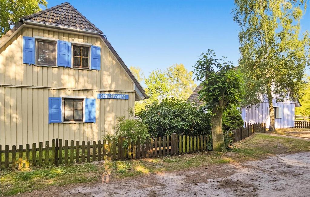 a white house with a fence and a tree at Amazing Home In Prerow With Wifi in Prerow