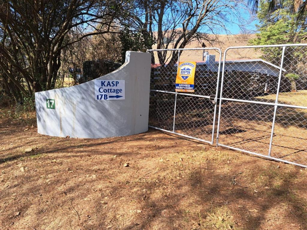 a skate ramp behind a fence with a gate at KASP Cottage in Underberg