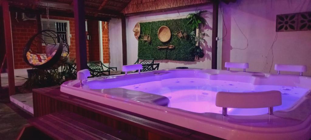 a large purple bath tub with a chair in it at Pousada Angatu alter in Alter do Chao