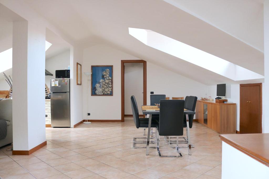 a dining room with a table and black chairs at Lovely Apartment near Canal - Via Foscolo in Corsico