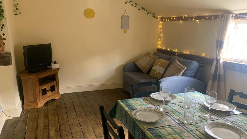 a living room with a table and a couch at Becs in Leominster