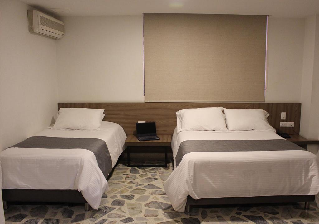 Postel nebo postele na pokoji v ubytování Hotel D' Leon