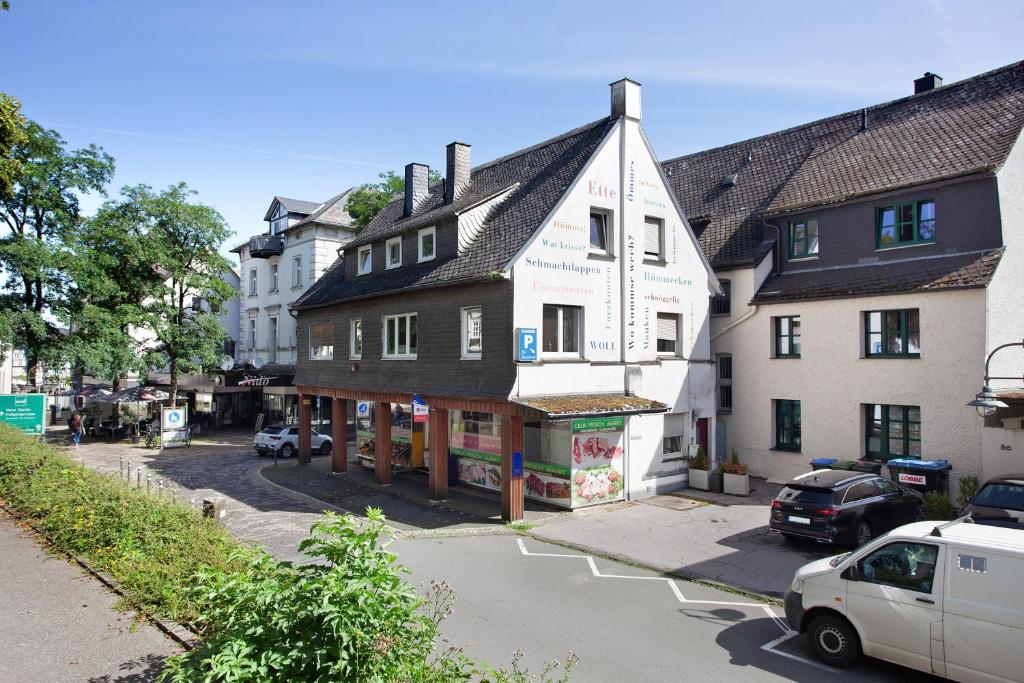 a building in a town with a car parked in front at Schatzkiste Brilon in Brilon