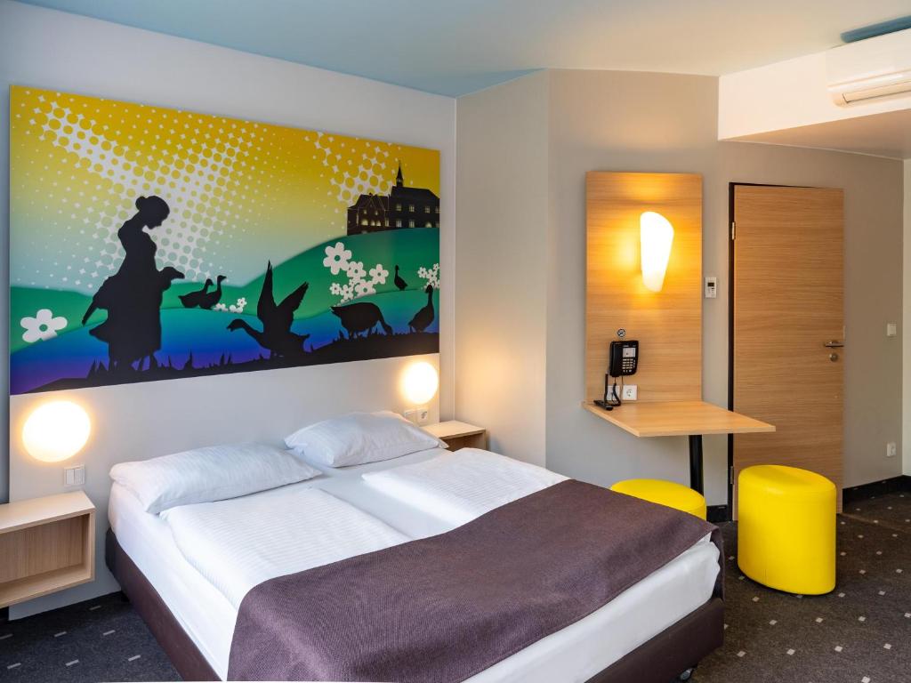 Postel nebo postele na pokoji v ubytování B&B Hotel Göttingen-City
