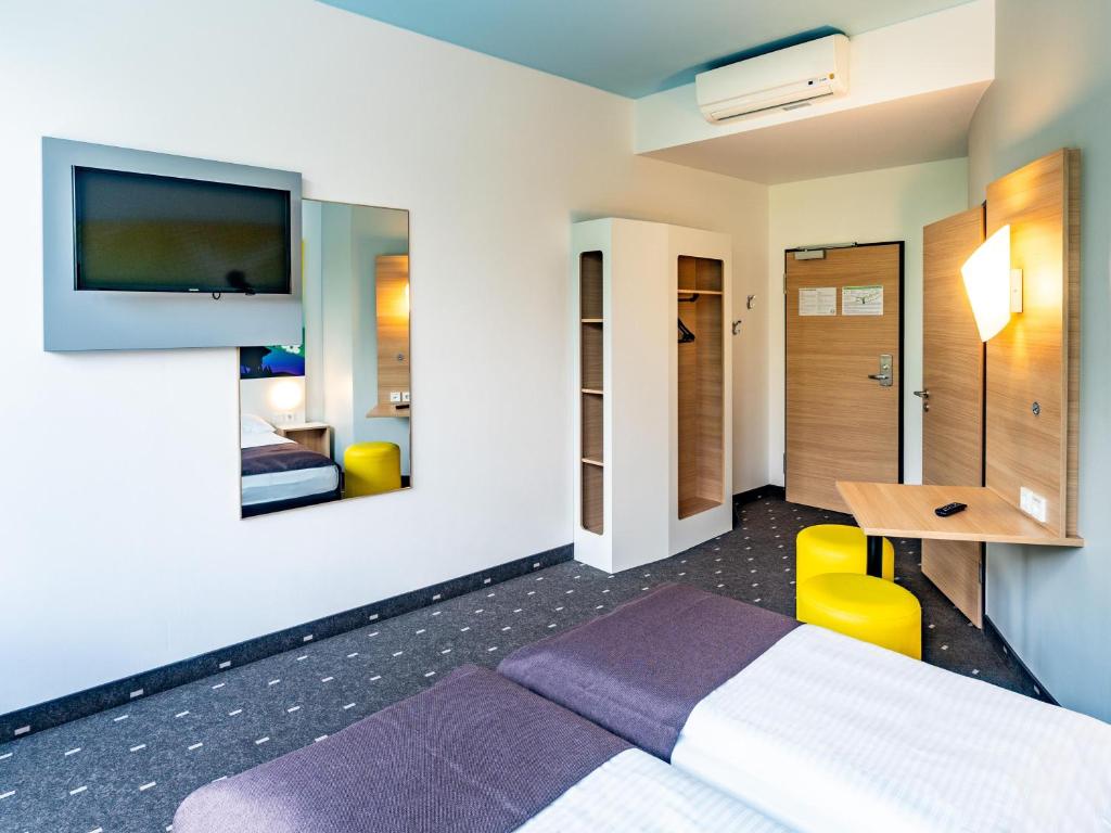 Postel nebo postele na pokoji v ubytování B&B Hotel Göttingen-City