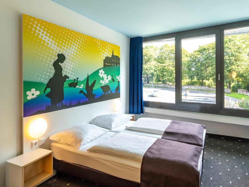 Postel nebo postele na pokoji v ubytování B&B Hotel Göttingen-City