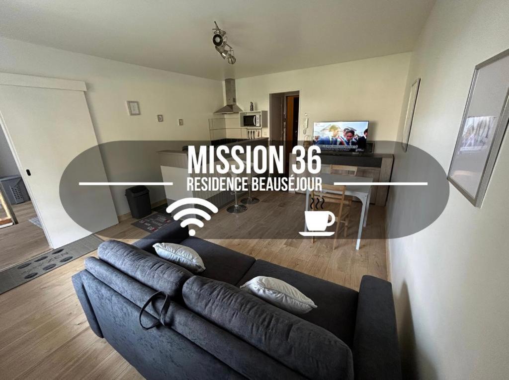 Una sala de estar con un sofá azul y una mesa. en Mission 36 - Wifi - Calme et tranquillité - Résidence Beauséjour, en Troyes