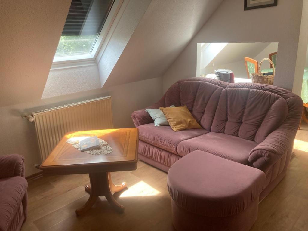 a living room with a purple couch and a table at Alter Rhin 