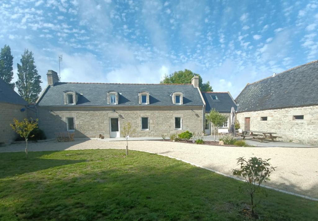 zewnętrzny widok na duży kamienny dom w obiekcie La Ferme de Penanguer w mieście Loctudy