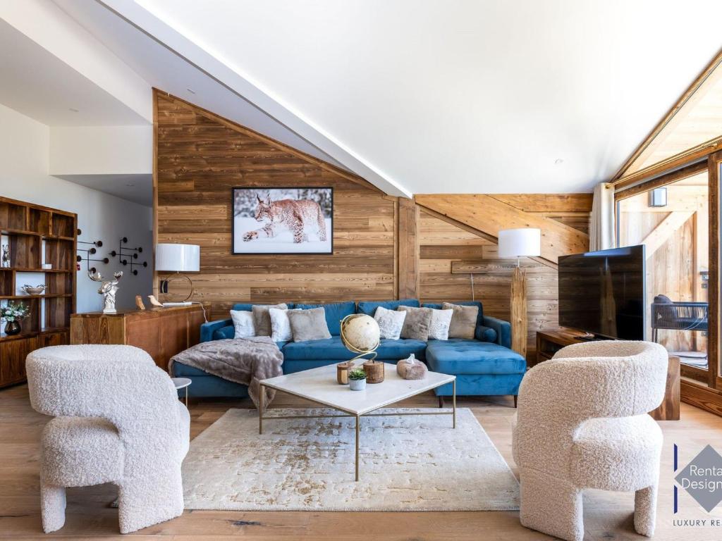 a living room with a blue couch and two chairs at Appartement Courchevel, 5 pièces, 8 personnes - FR-1-664-21 in Courchevel