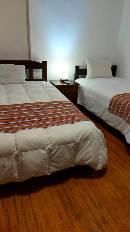 Postel nebo postele na pokoji v ubytování KAARO HOUSE CUSCO