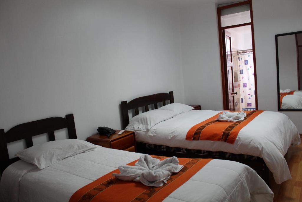 Postel nebo postele na pokoji v ubytování KAARO HOUSE CUSCO