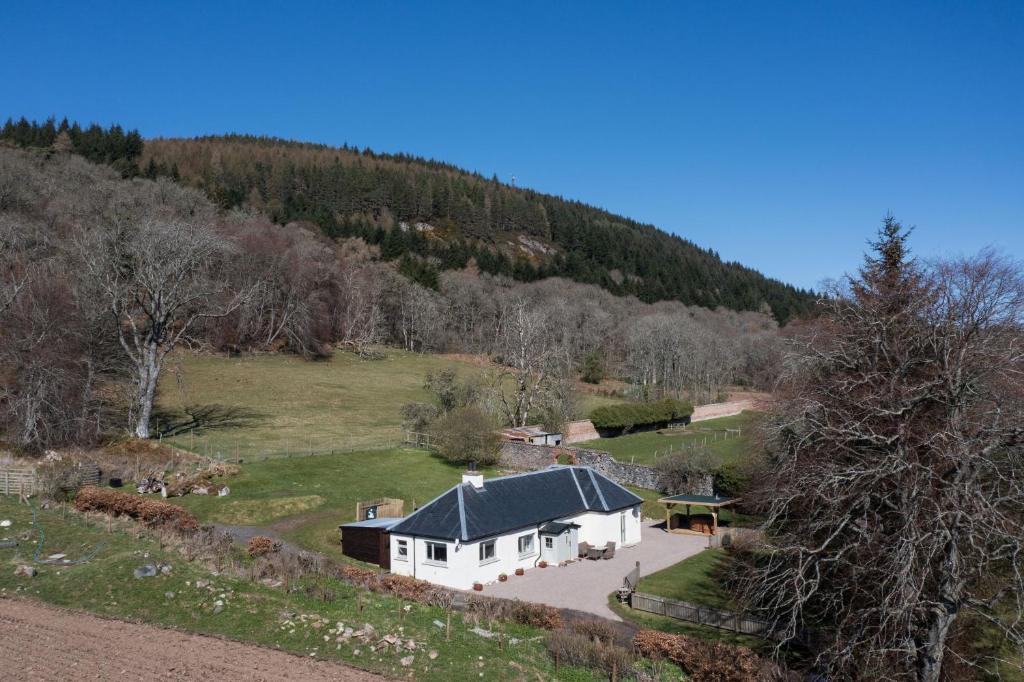 an aerial view of a house in a field at Glen View in Inverness