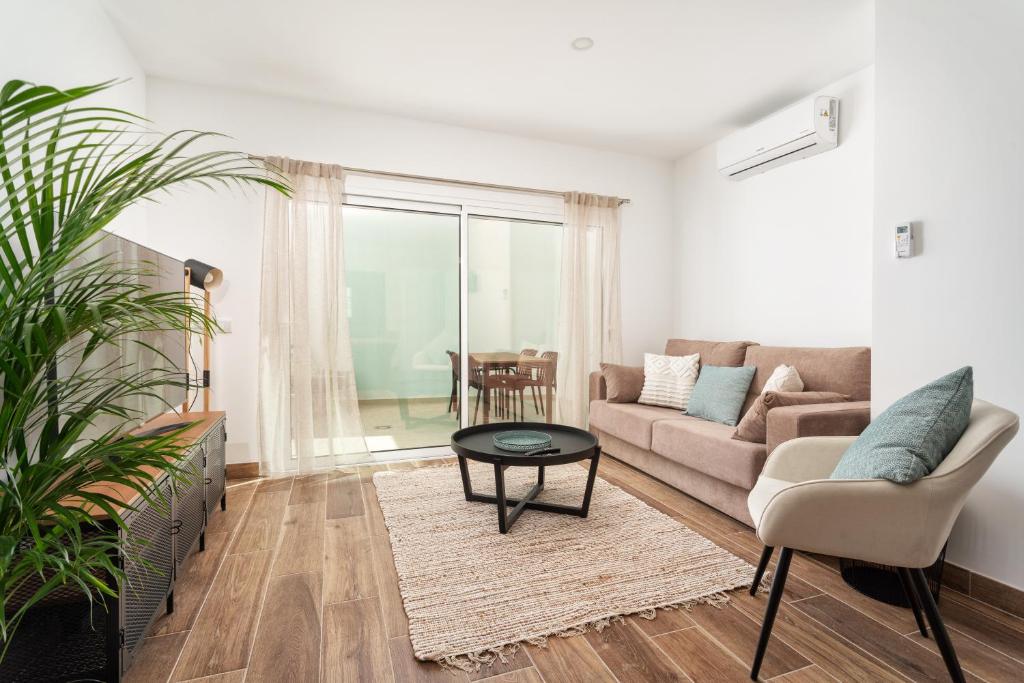 a living room with a couch and a table at Privilege Casa dos Capuchinhos, in the heart of Faro in Faro