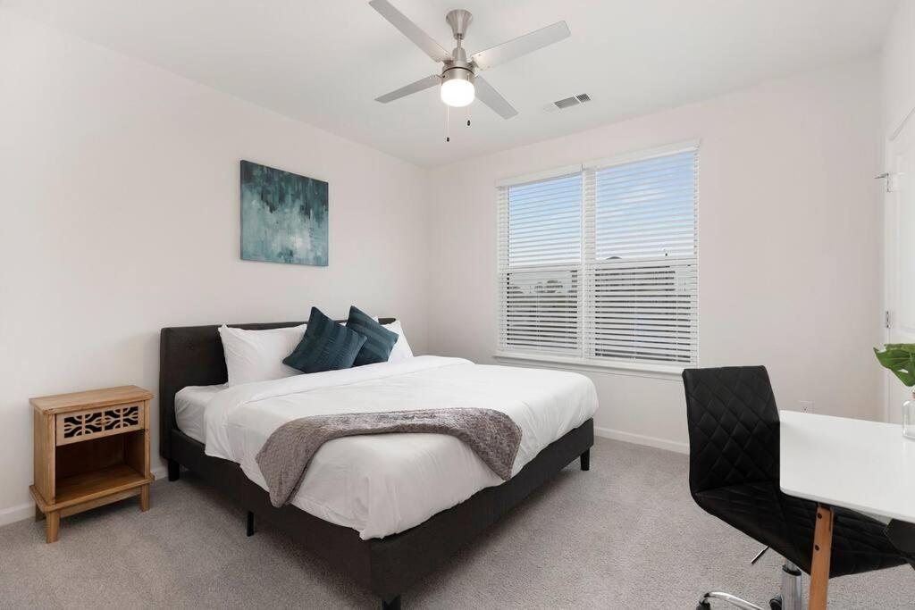 a bedroom with a bed and a ceiling fan at Modern Stylish Concord Condo in Concord