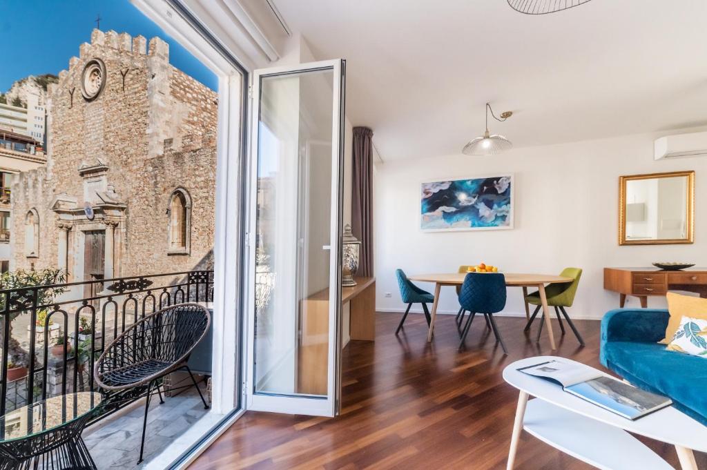 a living room with a view of a building at Castalia Apartments & Rooms Duomo Taormina in Taormina