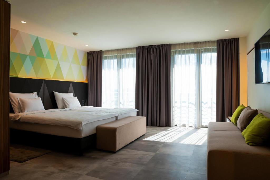 Ένα ή περισσότερα κρεβάτια σε δωμάτιο στο Austria Trend Hotel Ljubljana