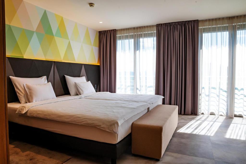Ένα ή περισσότερα κρεβάτια σε δωμάτιο στο Austria Trend Hotel Ljubljana