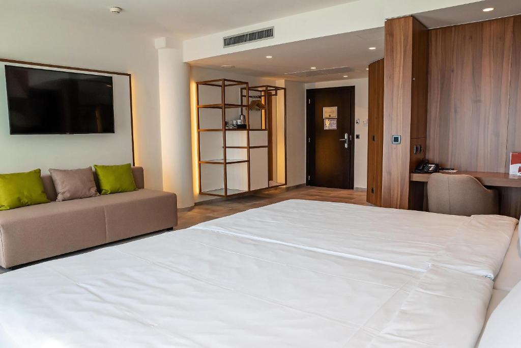 Ένα ή περισσότερα κρεβάτια σε δωμάτιο στο Austria Trend Hotel Ljubljana