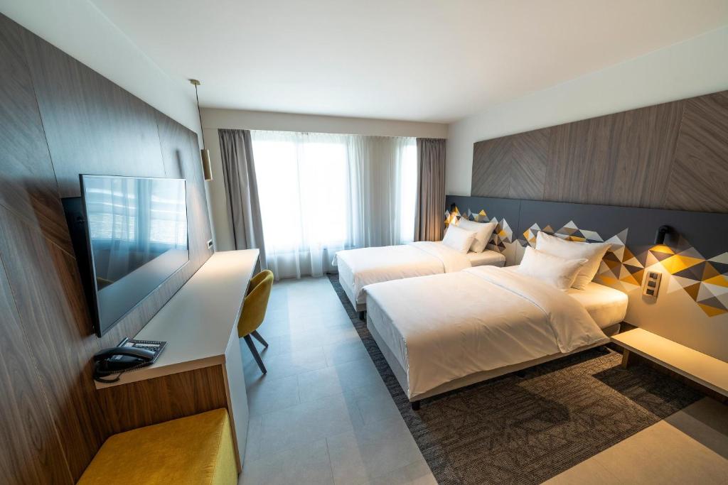 Ένα ή περισσότερα κρεβάτια σε δωμάτιο στο Austria Trend Hotel Ljubljana