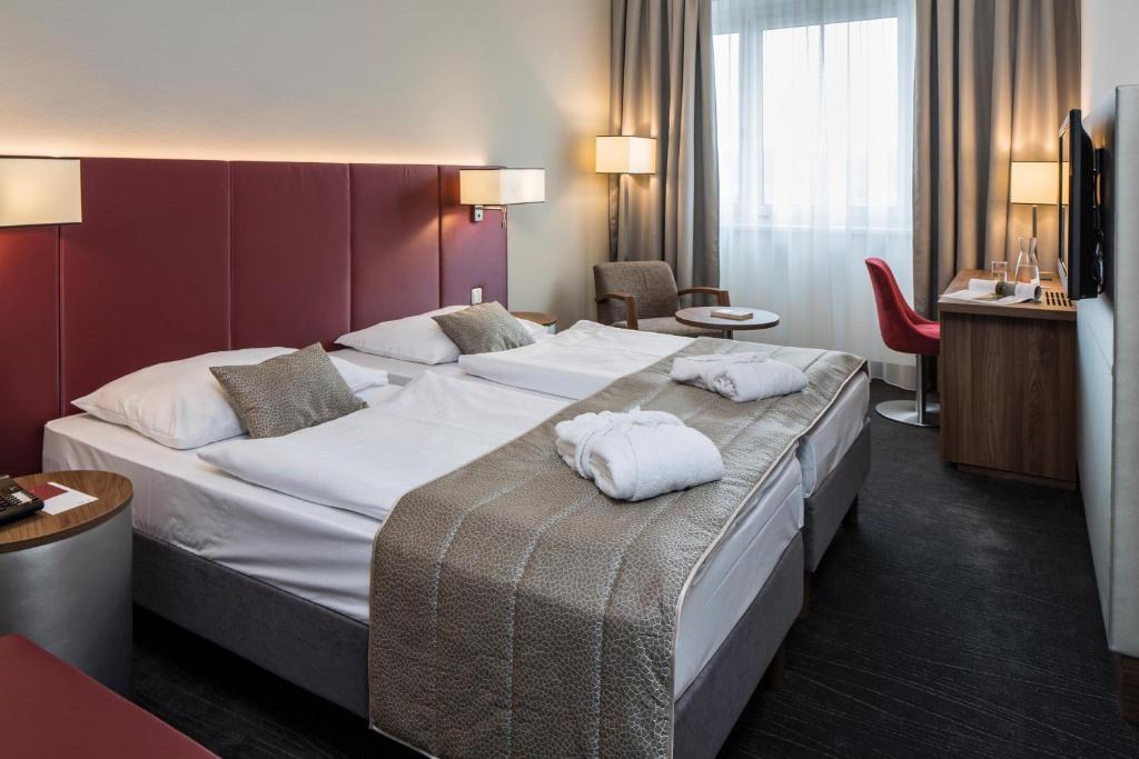 Postel nebo postele na pokoji v ubytování Austria Trend Hotel Europa Salzburg