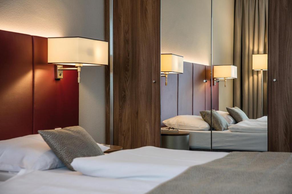 Postel nebo postele na pokoji v ubytování Austria Trend Hotel Europa Salzburg