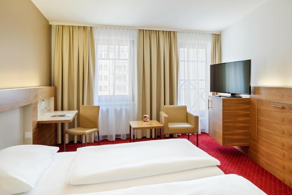 Postel nebo postele na pokoji v ubytování Austria Trend Hotel Anatol Wien
