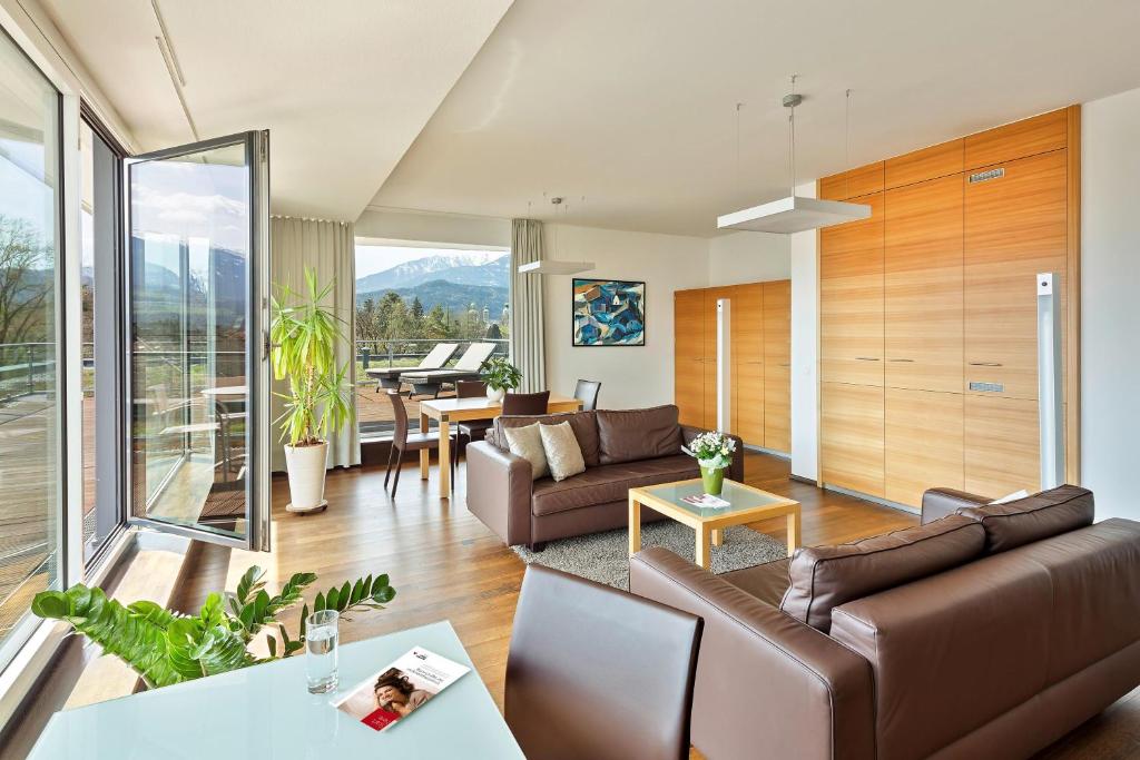 a living room with a couch and a table at Austria Trend Hotel Congress Innsbruck in Innsbruck