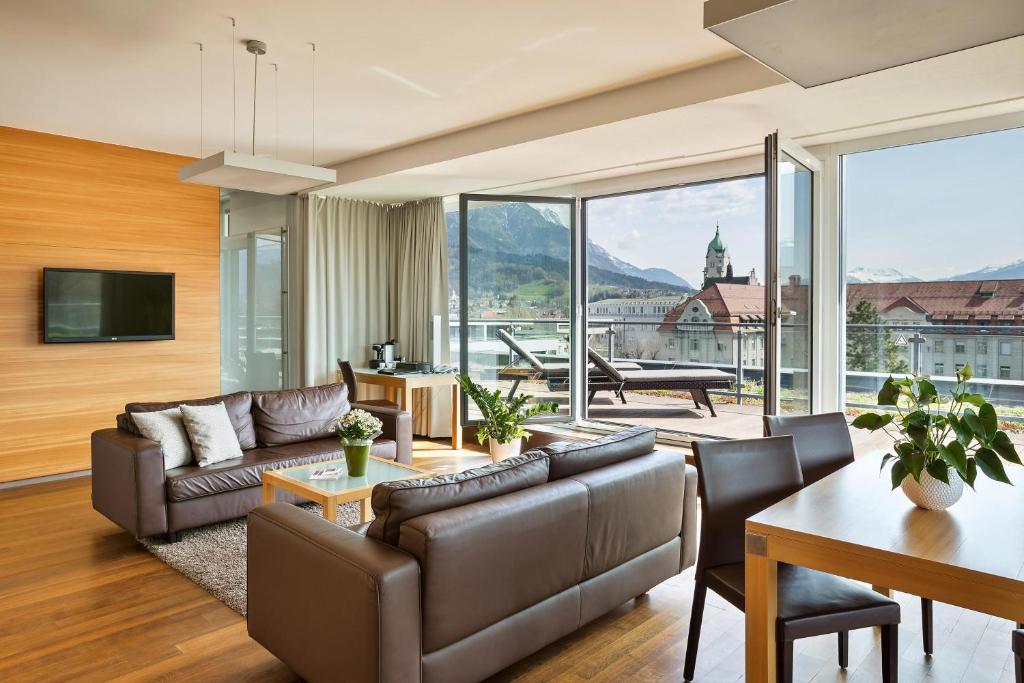 a living room with a couch and a table at Austria Trend Hotel Congress Innsbruck in Innsbruck