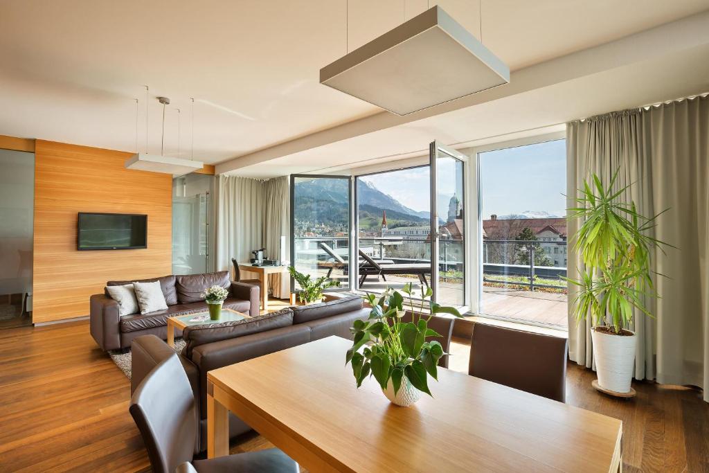 a living room with a couch and a table at Austria Trend Hotel Congress Innsbruck in Innsbruck