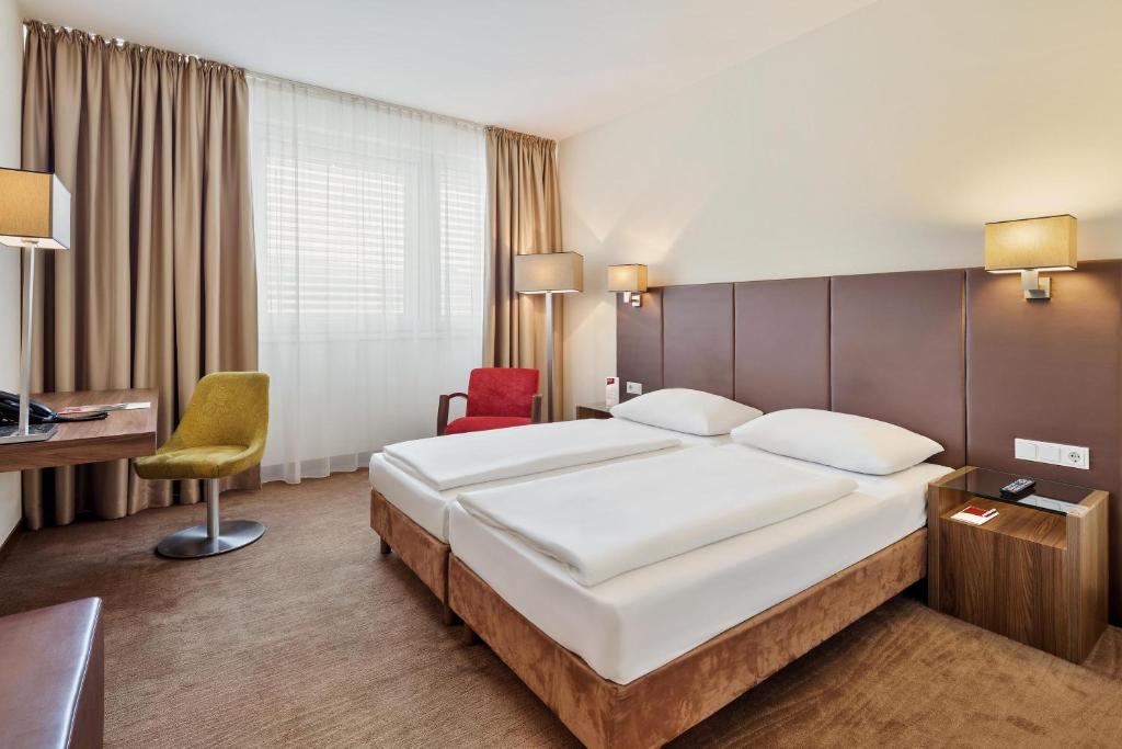 Postel nebo postele na pokoji v ubytování Austria Trend Hotel Doppio Wien