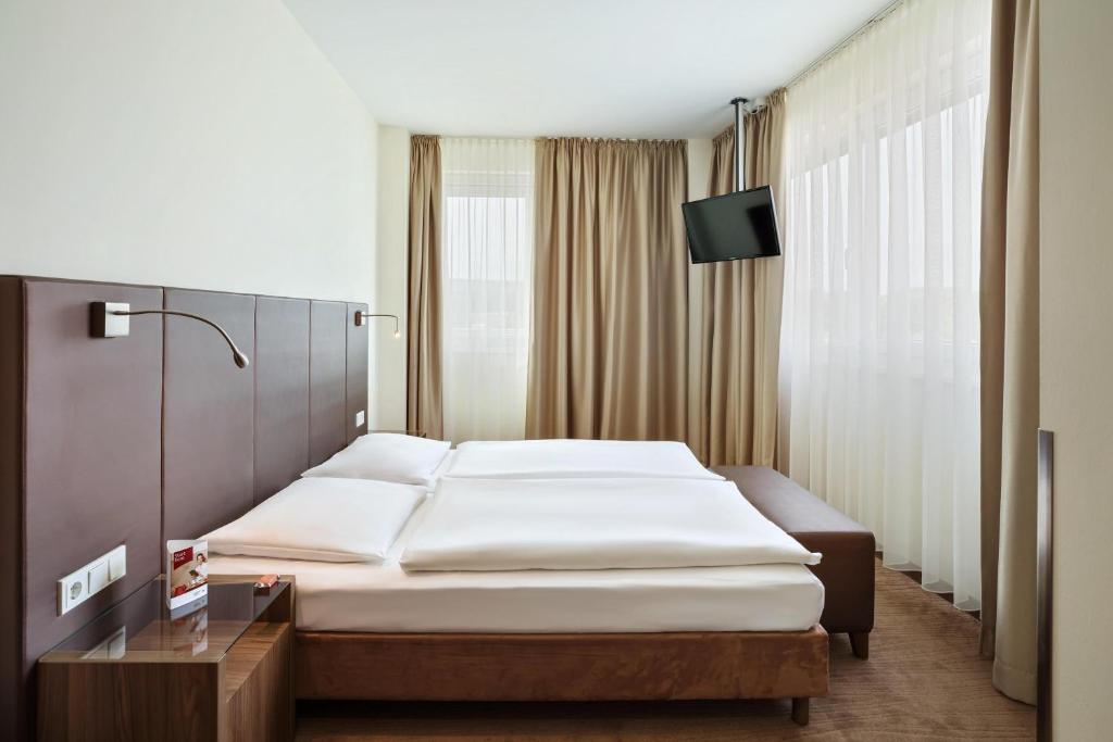 Postel nebo postele na pokoji v ubytování Austria Trend Hotel Doppio Wien