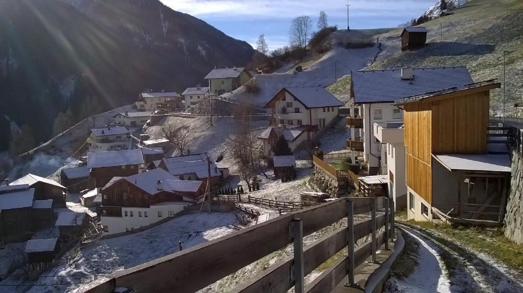 a village on a hill with snow covered roofs at Haus Franziska in Kappl