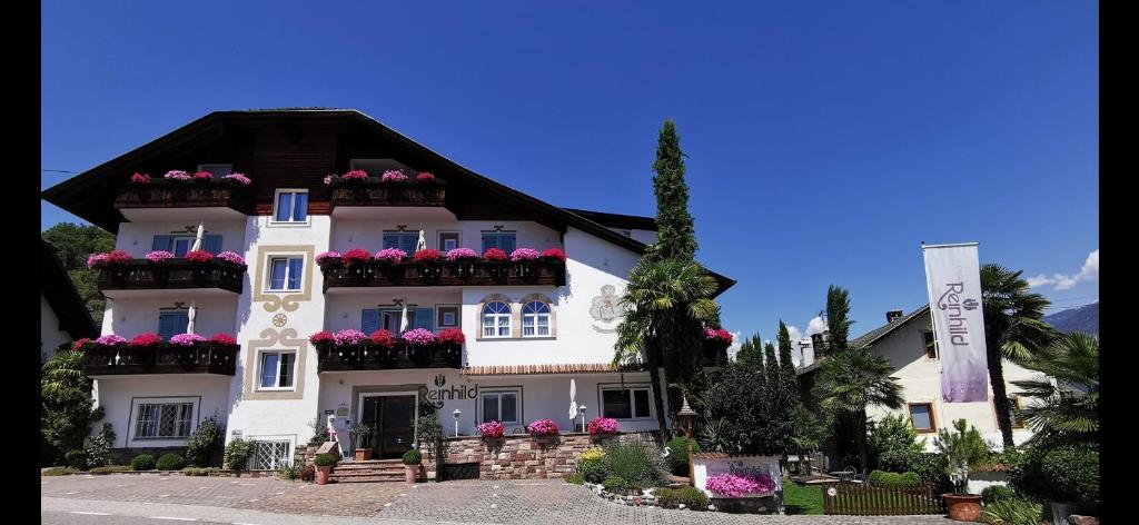 a large white building with flower boxes on it at Residence Reinhild in Nalles