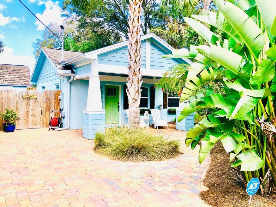 a blue house with a palm tree in front of it at The 2 Bedroom Jacksonville Blue Bungalow in Jacksonville