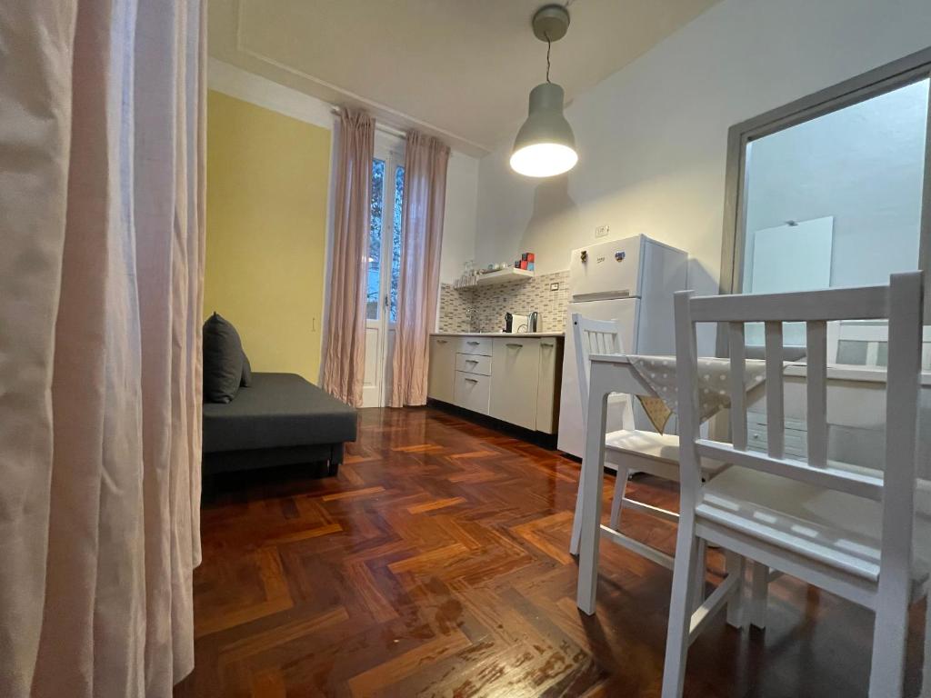 a living room with a table and a kitchen at Garden suite / del ducato in Parma