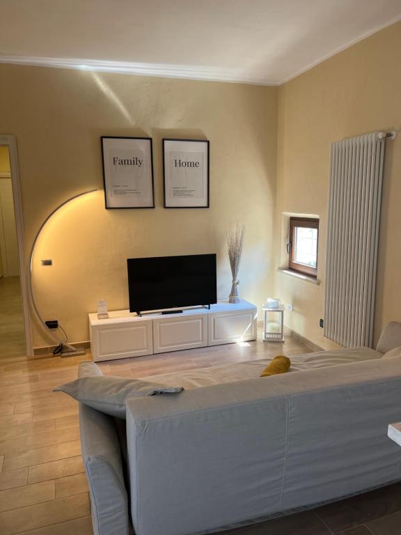 a living room with a couch and a flat screen tv at Cecco Guest house in Pisa