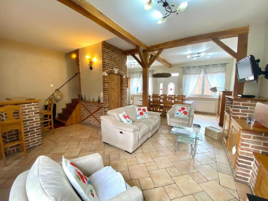 a living room with white couches and a television at Maison Au champ du souvenir 5 chambres 8 personnes in Bécordel-Bécourt