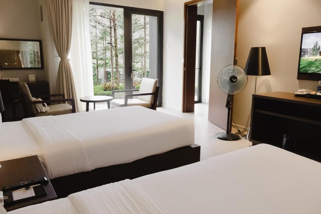 Postel nebo postele na pokoji v ubytování Terracotta Hotel & Resort Dalat