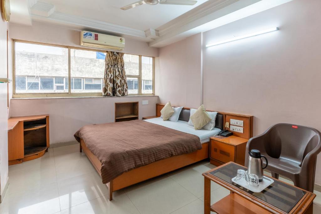 Postel nebo postele na pokoji v ubytování Hotel Sanmati