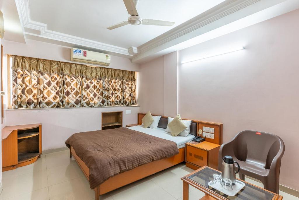 Postel nebo postele na pokoji v ubytování Hotel Sanmati