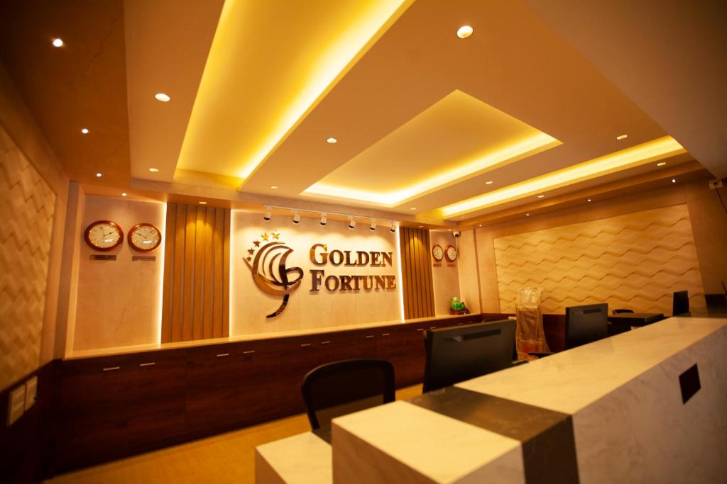 a restaurant with a table and a sign that reads golden horizons at Golden Fortune Hotel in Bangalore